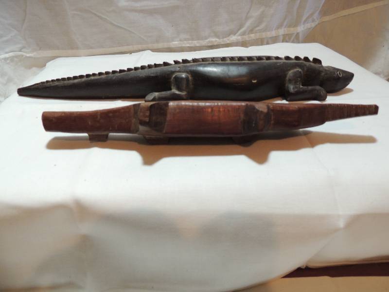 lot 302 image: 2 Carved alligators one in ironwood 2 X 12 and one in rosewood 3 X 17. Who wouldnt adore one of these for Christmas