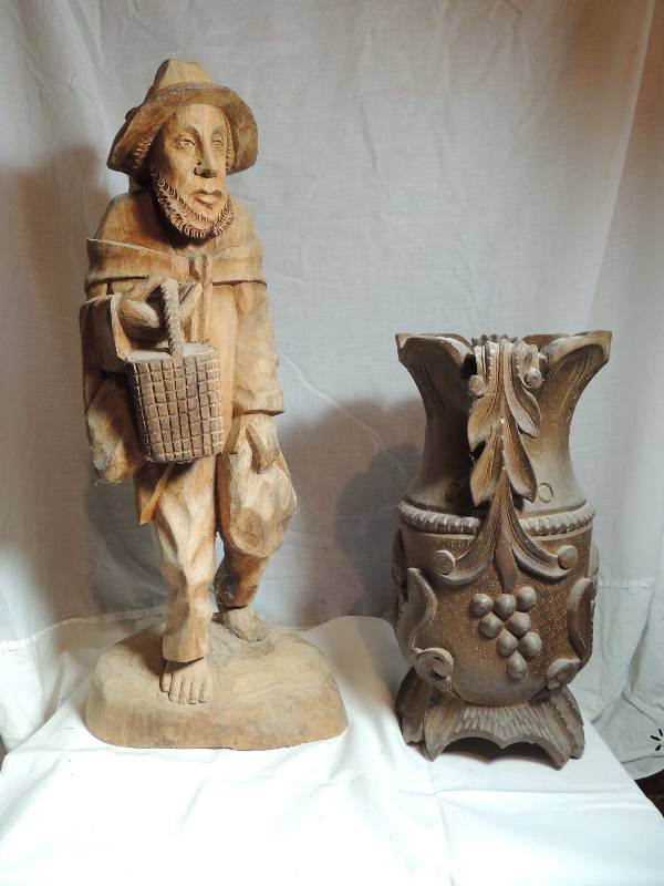 lot 516 image: Carved man with basket and bags barefoot teak HT 24 X 11    Carved wooden vase  15 X 8 X 8