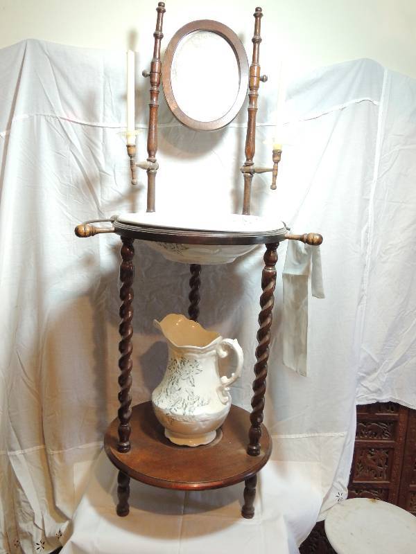 lot 280 image: Vintage washstand. Turned legs, Mirror, towel holder. Has basin and bowl. Tray at base. Candleholders 58 H 22 x 20