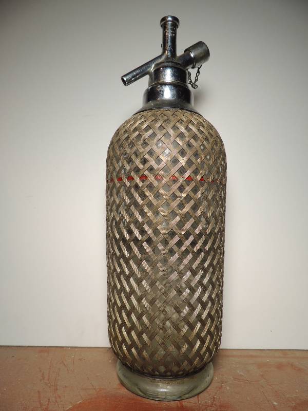 lot 225 image: Unique Seltzer bottle has metal lace covering