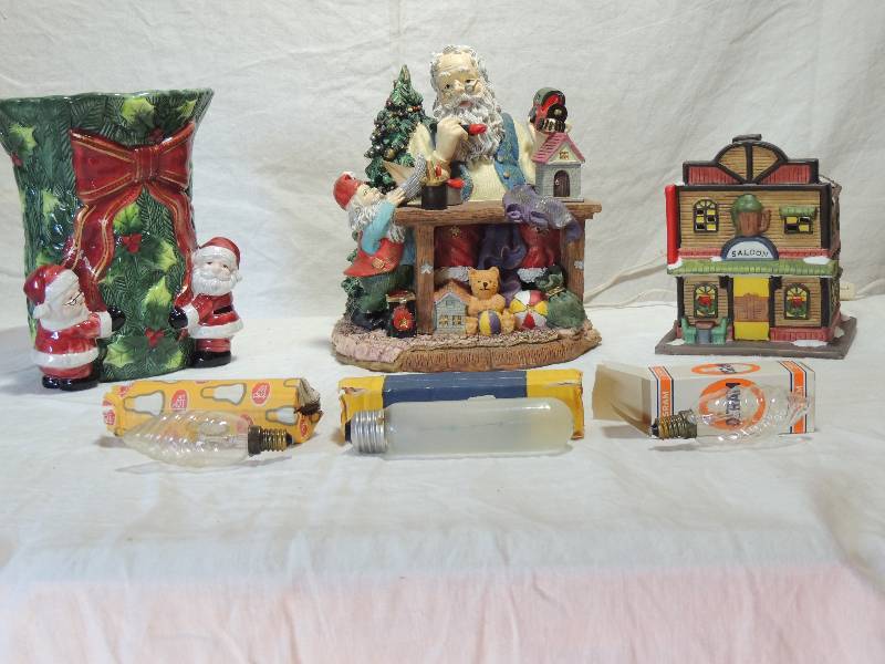 lot 442 image: Santa Workshop - Santa building toy, s Ceramic vase 9 Poinsettia with sash,  L lighted Saloon,   Osram lights 25w x 10-   40 w Frosted bulbs x 5