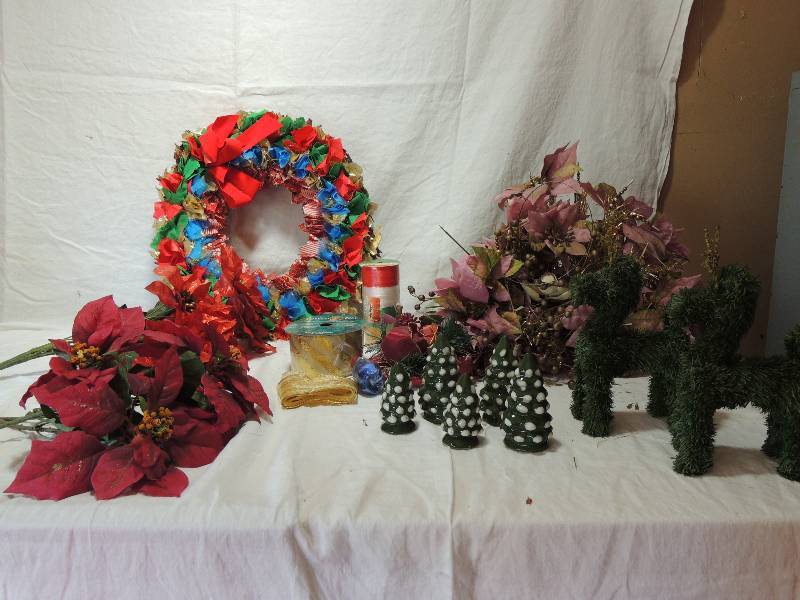 lot 454 image: Tub full of Christmas treasure - Pink poinsettias, Tie rag wreath, Garland deer, Red foil poinsettia, Ribbon, Ceramic trees 4 x 12 and 3 x 2