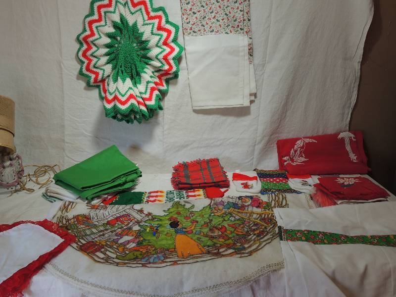lot 456 image: Christmas Linens- Crochet table skirt, Table cloths, Snow White Christmas skirt, napkins red and white needlepoint Christmas table cloth