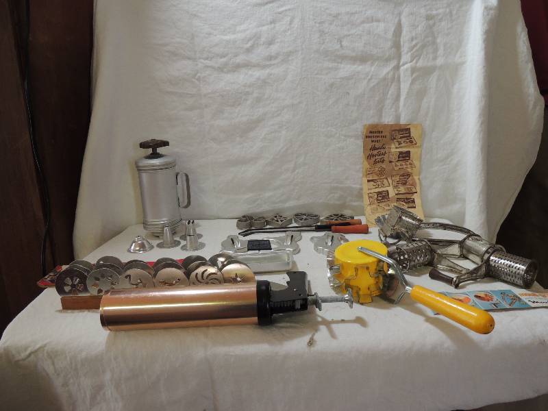lot 473 image: Cookie press with discs x 2, Mouli grater with 3 discs, Tart makerMOLDS