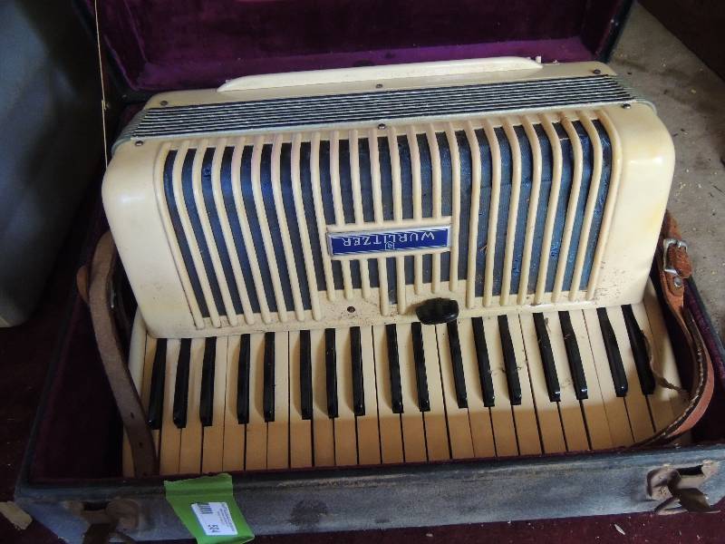 lot 504 image: Wurlitzer accordion in case with straps bellows in good condition
