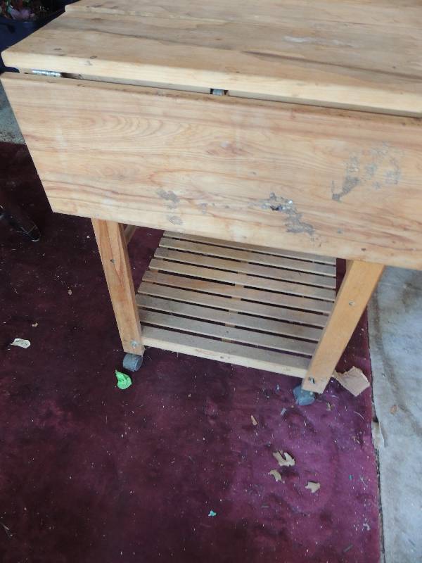 lot 505 image: Kitchen cart on wheels ,Drop sides Top has slight warp 19x24x30 blonde wood  (open 37 x 24 x30)