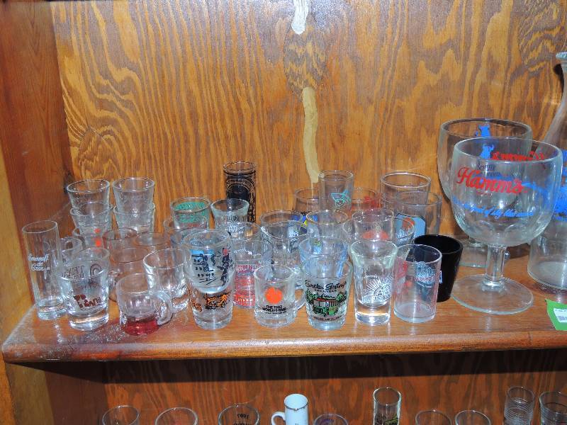 lot 360 image: Large lot of shot glasses with various logos