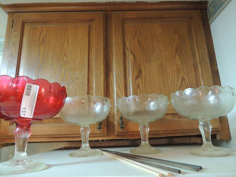 lot 137 image: 4 Compote dishes 3 clear 1 red. No chips or scratches noted