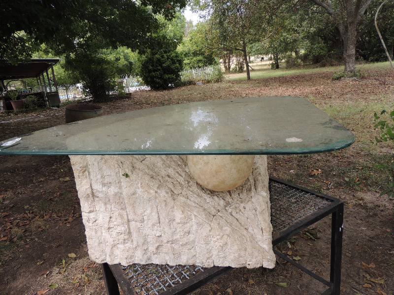 lot 641 image: UNIQUE SIDE TABLE - WHITE FAUX STONE CURVED BACK WITH BALL ON FRONT, GLASS TOP  BASE - 16H 18D, CURVED TOP - 40 X 37