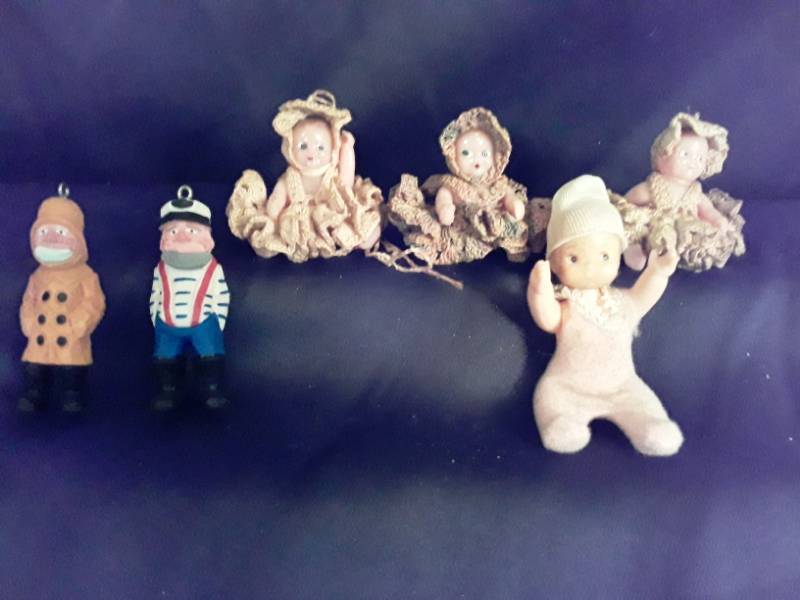 lot 117 image: 3 Crochet dolls 3  tall, 4 baby doll and  2 fisherman wood carved ornaments app. 2  12  tall