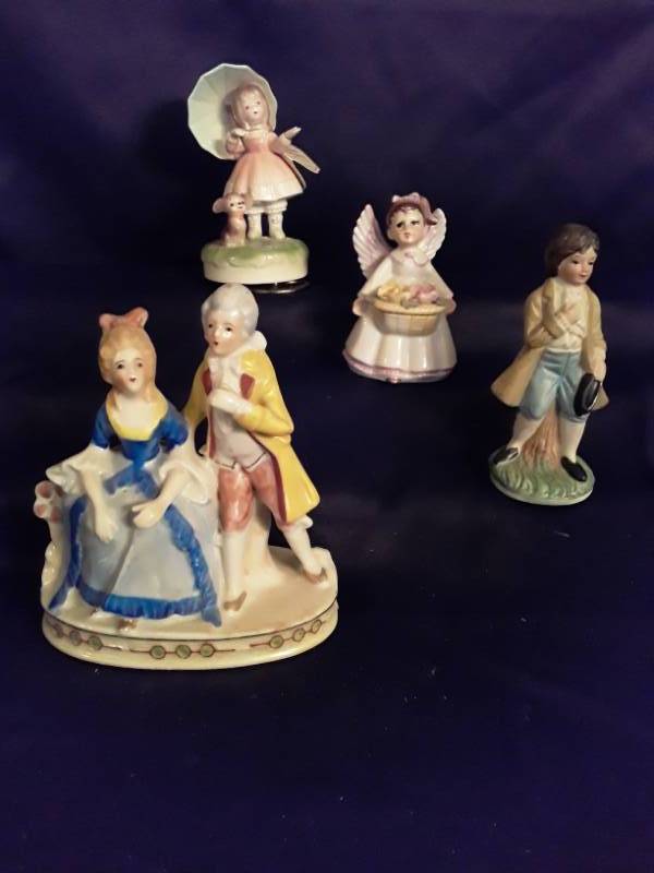 lot 108 image: 4 Porcelain figurines- 1 Victorian couple 1  angel with basket and 1 girl with umbrella (music box)