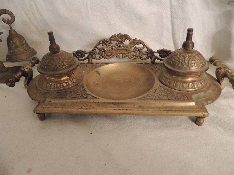 lot 128 image: Brass  double pot inkwell , 8 umbrella , Buda candle holder and Elephant Bell