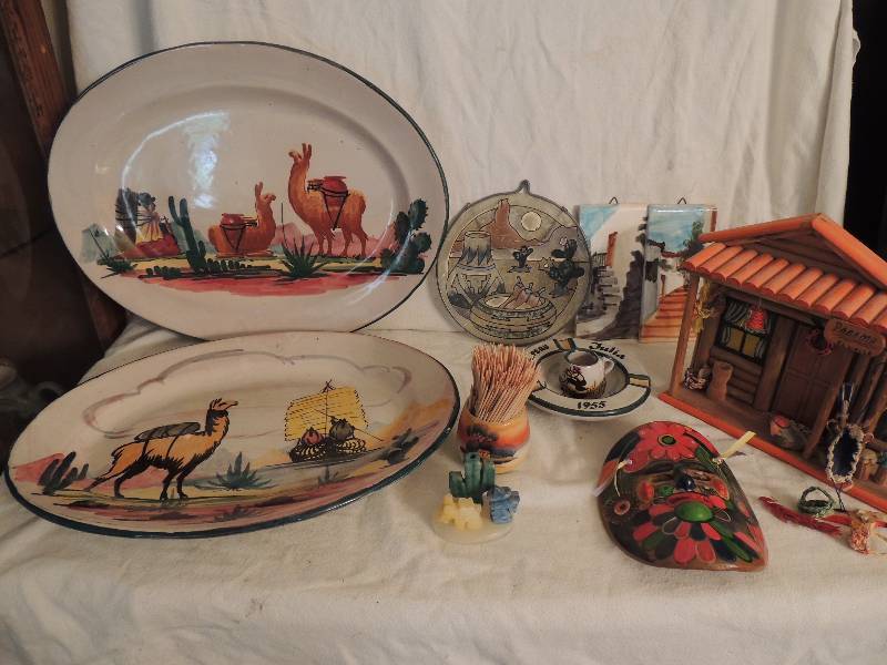 lot 30 image: Peruvian lot- 2 platters one 14 and one 16 has crack on back, ash tray, small cup,2 hand painted tiles, tooth pick holder, ONYX figurine with cactus and donkey, 6x4 mask and Panama shadow box 8x9