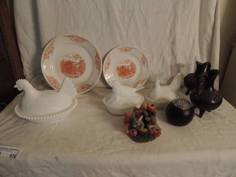 lot 674 image: Large glass platter 18,  Chicken on a nest 5 12x 2 , Chicken on a nest 7 x 1, 2 Porto Ferreira plates 1 dinner one salad made in Brazil,  2 - 6 clay footed pitchers, apple soap carving 1 charming tails friends are a Bushel of Fun