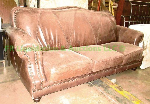 lot 62 image: Bonded leather sofa with button tufted trim