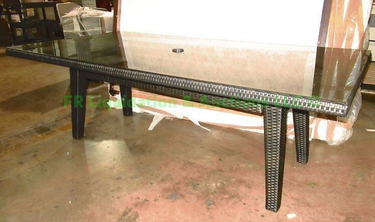 lot 215 image: Wicker patio table with glass top overlay, 68 x 44 x 30