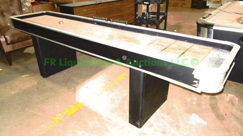 lot 219 image: Atomic gaming tables 9ft Platinum Shuffleboard Table, one corner needs repaired