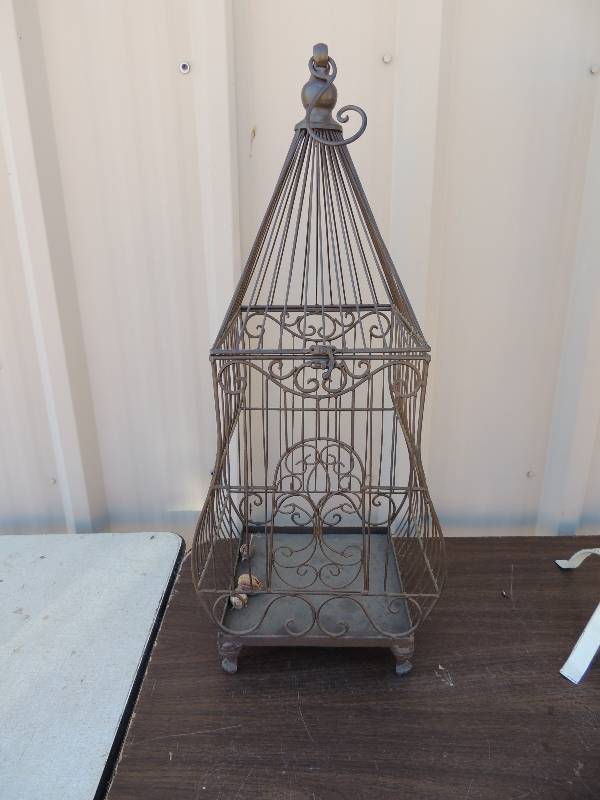 lot 724 image: Metal bird cage that could hang   (or could be part of Floral design) 29 tall  12 wide 10 deep
