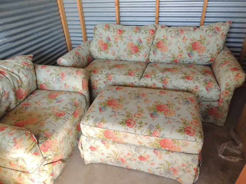 lot 691 image: Love Seat chair with ottoman. Light green and red floral design Nice condition no stains apparent.