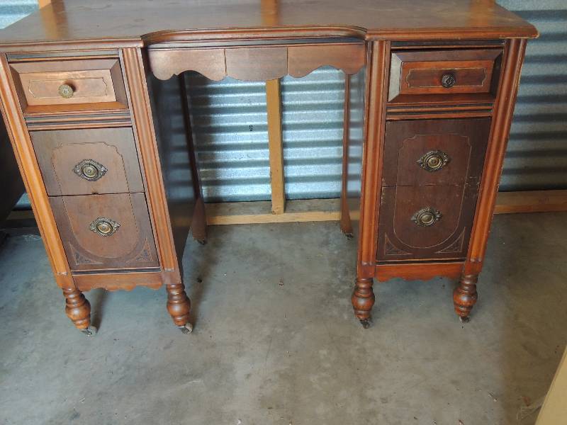 lot 694 image: Wooden vanity (one wheel missing) needs some TLC. Has place for mirror 41L  31 H 18D