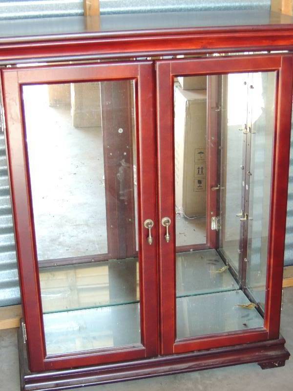 lot 695 image: Cherry and walnut cabinet with glass shelves and doors. Needs new glass holders for doors. Nice condition but small scratch on top  40 H 32 L 14D