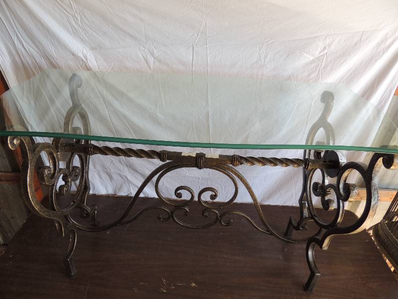 lot 714 image: Heavy metal -  glass top coffee table (glass included no chips) 29 tall 42 long