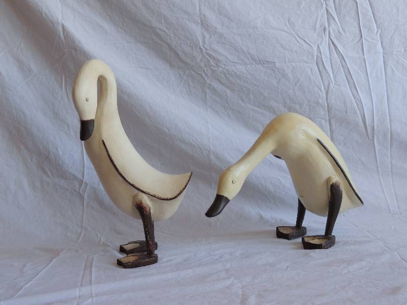 lot 730 image: 2 matching wooden swans -  standing 13  12 tall,  squatting 9 tall