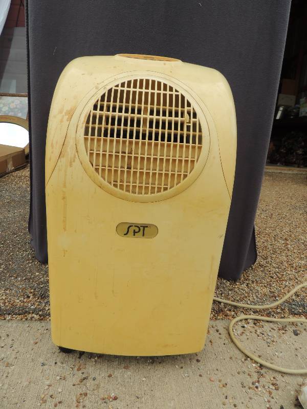 lot 812 image: SPT portable air conditioner model # WA-1220E Voltage 115V-60Hz Power consumption 965w-8.5A Refrigerant R2217.3 oz.  Working condition. Came from a smokers home will need to be cleaned