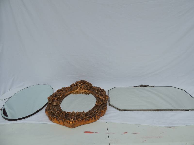 lot 824 image: Heavy oval wall mirror with chair hanger 22wx13T   gold mirror 26 tall 18 W   Vintage metal frame mirror with decorative metal ribbon on top 17.5 tall 27.25 Long