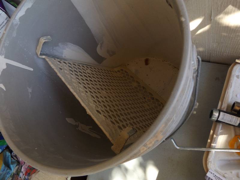 lot 933 image: Paint bucket,  caulking gun   2 paint trays and paint ruler