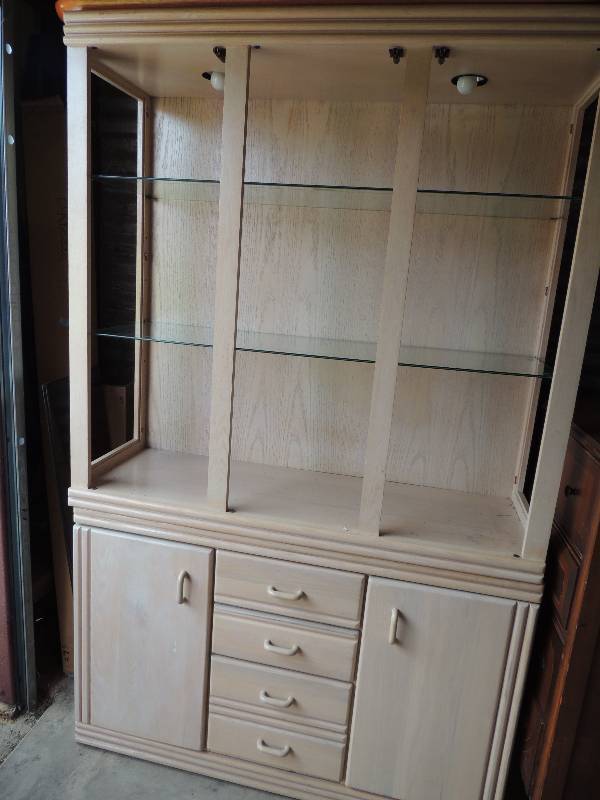 lot 852 image: Two piece lighted cream color hutch with glass shelves, 2 doors and 4 drawers 77 Tall x 16.5 depth and 47.5 length