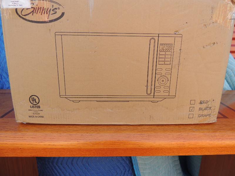 lot 864 image: Ginnys black and silver 0.9 cuft microwave oven. Includes Manuel and recipes NIB never opened