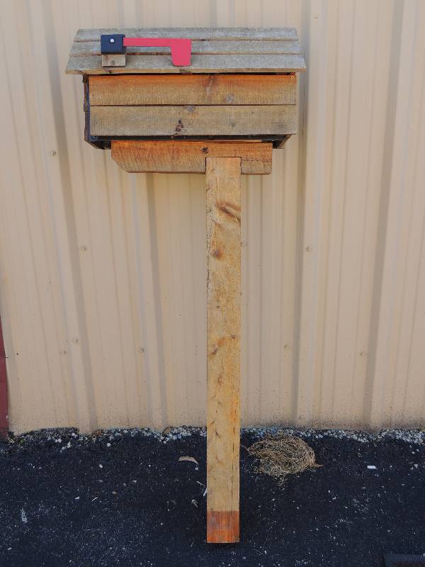 lot 868 image: Wooden mailbox with stand. Box resembles house for dcor