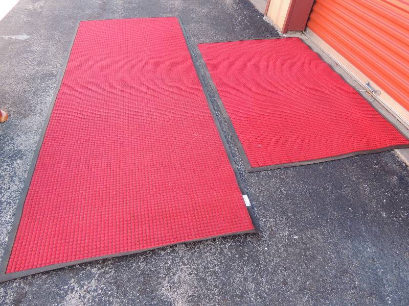 lot 876 image: 2 red Waterhog Carpet Mat - rubber floor mats- one is 116  x 45 and the second measures 58 x 34