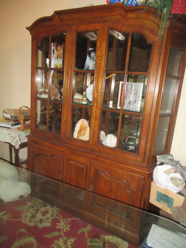 lot 14 image: BEAUTIFUL SOLID WOOD HUTCH WITH BUILT IN LIGHTING 2 GLASS DOORS ON TOP HALF AND 2 STORAGE DOORS ON BOTTOM MEASURES APPROX. 72 X 18 X 84 CONTENTS NOT INCLUDED MATCHES LOT 15,21 AND 22