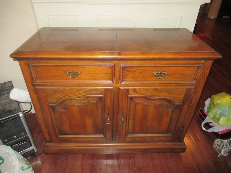 lot 15 image: DINING ROOM CABINET WITH FLIP OPEN TOP HAS 2 DRAWERS AND 2 DOORS FOR STORAGE MEASURES APPROX. 32 X 19 X 34 MATCHES LOT 14,21 AND 22