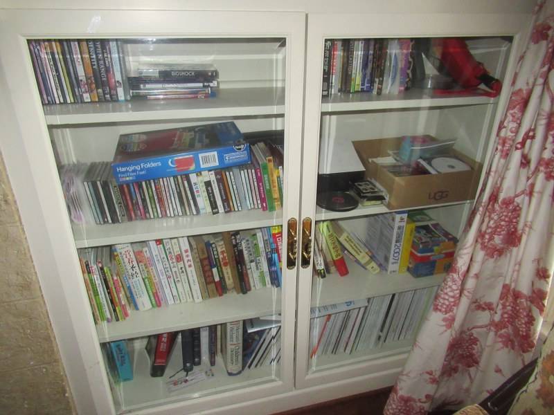 lot 25 image: CONTENTS OF BOOK SHELVES INCLUDING CHILDRENS BOOKS, DVDS, CDS, AND MORE SHLEVING NOT INCLUDED