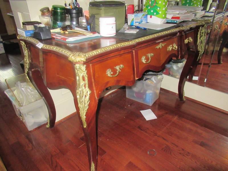 lot 28 image: ANTIQUE MID-CENTURY DESK WITH METAL ORNATE DECROTIVE EDGES MEASURES APPROX. 51 X 27 X 31 12 CONTENTS NOT INCLUDED
