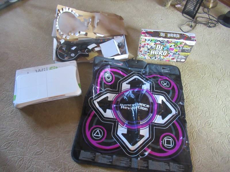 lot 53 image: Wii ACCESSORIES INCLUDING Wii FIT, GUITAR HERO, DANCE DANCE REVOLUTION AND DJ HERO
