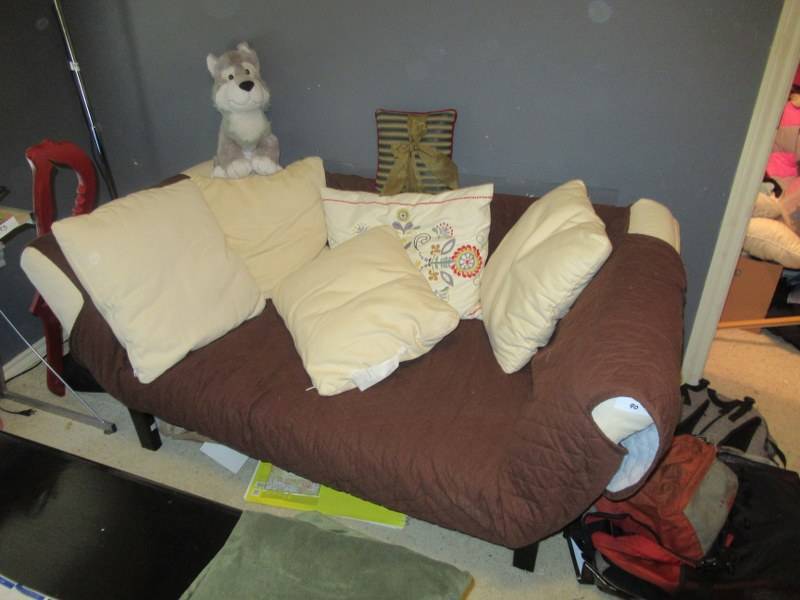 lot 90 image: BLACK WOOD FUTON WITH WHITE CUSHION INCLUDES COUCH COVER AND PILLOWS 61 X 36 X 14