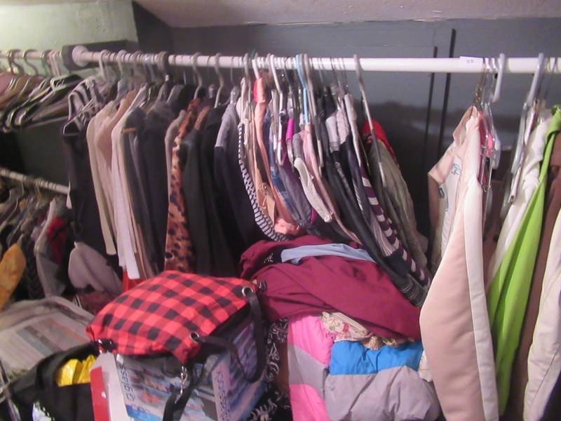 lot 112 image: CONTENTS OF CLOSET INCLUDES HIGH END WOMENS SIZE SMALL TO PETITE CLOTHING AND COATS, METRO RACK, COMFORTER AND MORE BUYER MUST TAKE ALL