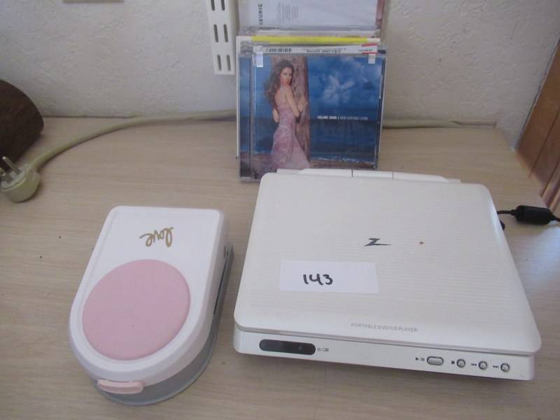 lot 143 image: LG PORTABLE DVDCD PLAYER, FISKARS TERESA COLIINS INTRICATE SHAPE PUNCH LOVE AND VARIOUS CDS