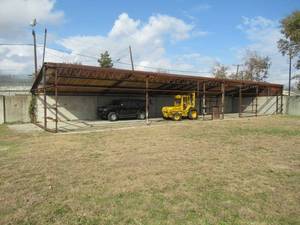 lot 23 image: LARGE COVERED STEEL AWNING  MEASURES APPROX. 53FT. LONG, 11FT OF COVERED ROOF 5FT UNCOVERED AND 12FT TALL BUYER WILL HAVE ADDITIONAL 60 DAYS TO REMOVE AND WILL COORDINATE WITH OWNER FOR REMOVAL