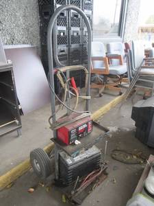 lot 58 image: CENTURY BATTERY STARTERCHARGER WITH AUTOMATIC SHUTOFF FOR 12 AND 6 VOLT BATTERIES ON DOLLY
