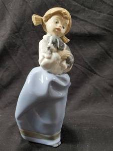 lot 123 image: NAO by Lladro Girl Carrying Sleeping Dog B270