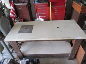 lot 39 image: INDUSTRIAL WORK TABLE WITH ELECTRICAL OUTLET AND SMALL METAL PLATE FOR WORKING 49 12 X 21 12 X 28 ALSO HAS WOOD AND LAMINATE TOP THAT FITS ON TOP IT MEASURES 48 X 45