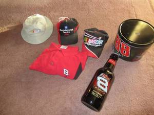 lot 40 image: NASCAR COLLECTABLES INCLUDING DALE JR. SHIRT XXL, LARGE BUDWEISER BOTTLE, 3 HATS AND TIN