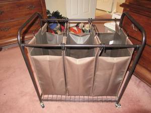 lot 62 image: ROLL AROUND CLOTHES HAMPER HAS METAL FRAME 30 X 18 X 29