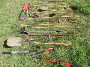 lot 201 image: YARD TOOLS INCLUDING CORONA TITANIUM PRUNERS, ORBIT TELESCOPING WAND WITH GUTTER CLEANING NOZZLE, 2 WOOD SAWS, SHOVELS, RAKES, HOES,POST HOLE DIGGER AND MORE