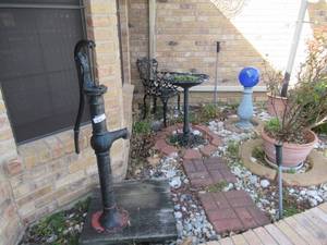lot 214 image: VINTAGE CAST IRON RED JACKET WATER PUMP, CAST IRON BIRD BATH, WROUGHT IRON CHAIR, BLUE GLOBE ON STAND AND PLANTERS